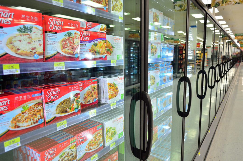 Supermarket freezer aisle kept cold by commercial refrigeration plant